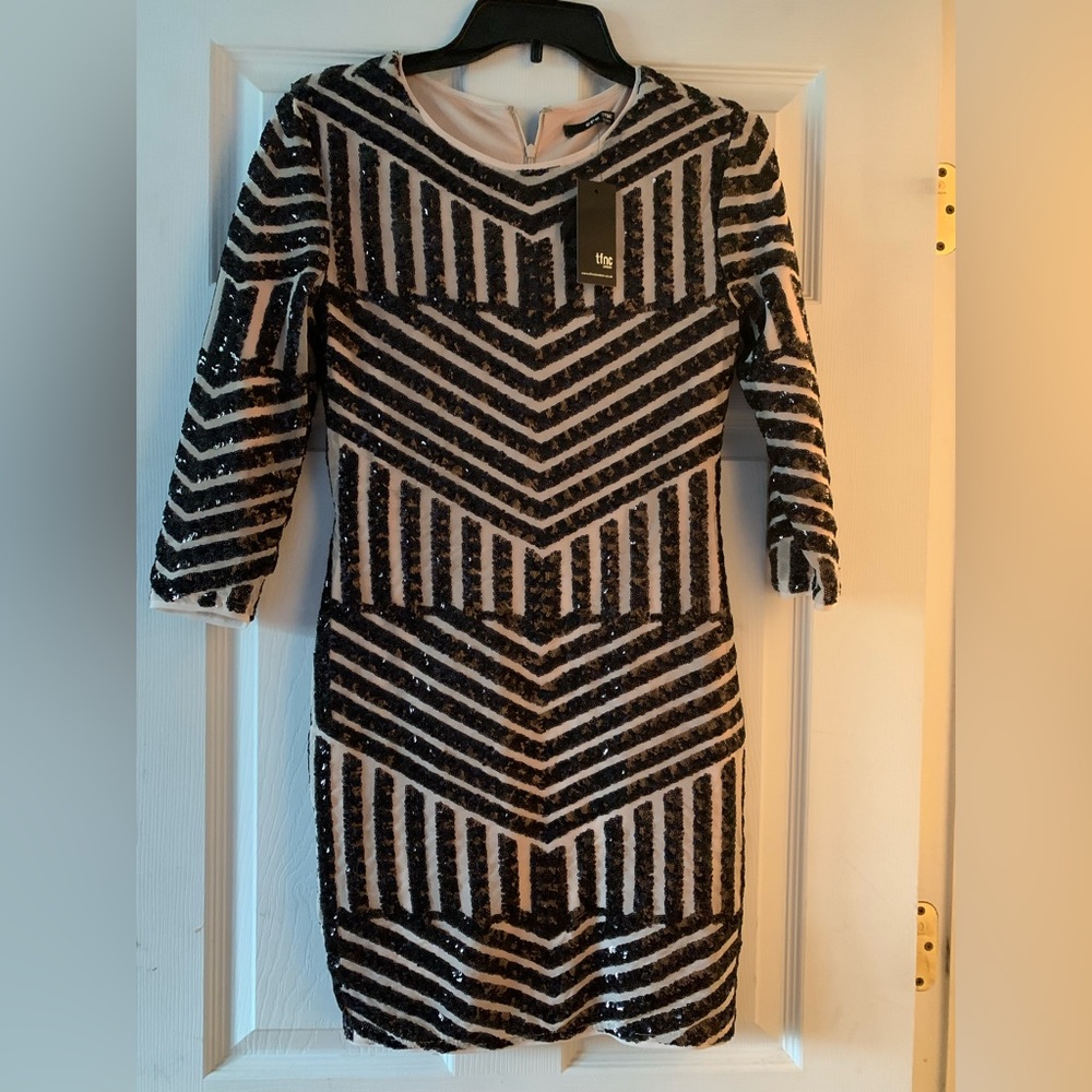 Super cute mini dress! Nude color with black beading. Adorable for a night out!
